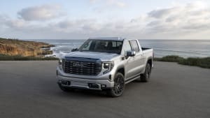 media image of the 2022 GMC Sierra Denali Ultimate parked on a cliffside road on the California coast