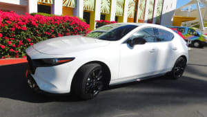 image of the 2023 Mazda3 Hatchback with a Palm Springs hotel in the background