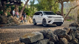 image of the Lexus TX outside a house with kids running towards it