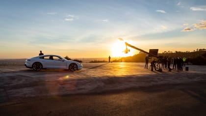 porsche taycan at sunset with a camera crew