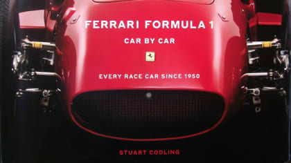 red Ferrari on the cover of "Ferrari Formula 1 - Car By Car".