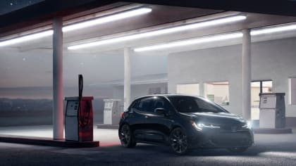 2021 Toyota Corolla Hatchback parked at a dim-lit gas station.