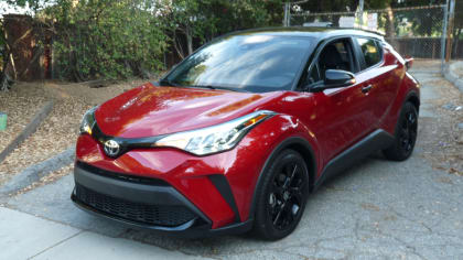 exterior front and left side of a red 2021 Toyota CH-R Nightshade parked on a driveway