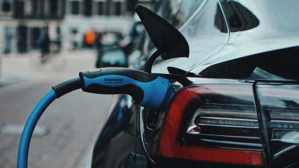 closeup of the power cable attached to a Tesla being charged