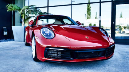 red Porsche parked outside of the Porsche Experience Center in Los Angeles during the 5th anniversary event.