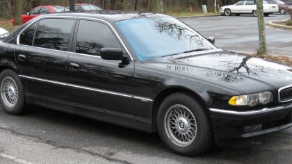 a black BMW parked on the side of the road