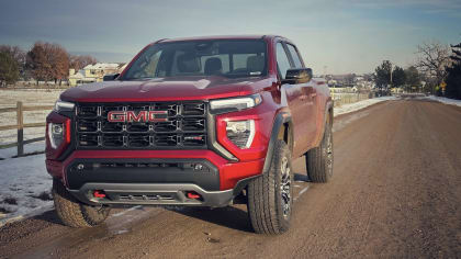 a red 2023 GMC Canyon on a dirt road