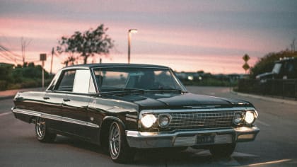 vintage car parked with the sundown in the background.
