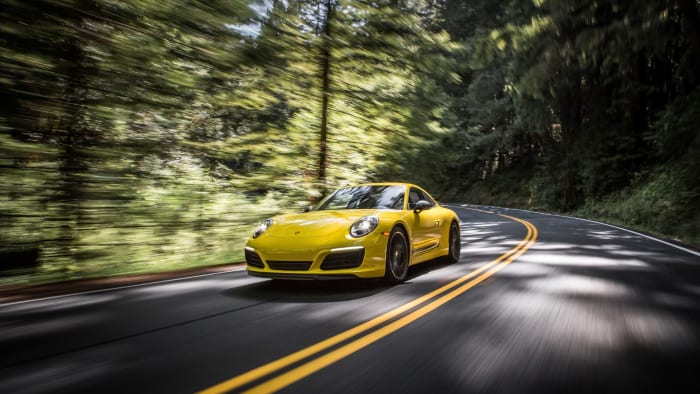 Yellow Porsche 911 driving on road
