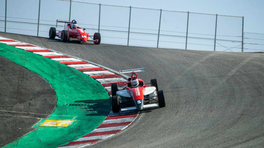 racers taking a corner at Allen Berg Racing School in Laguna Seca