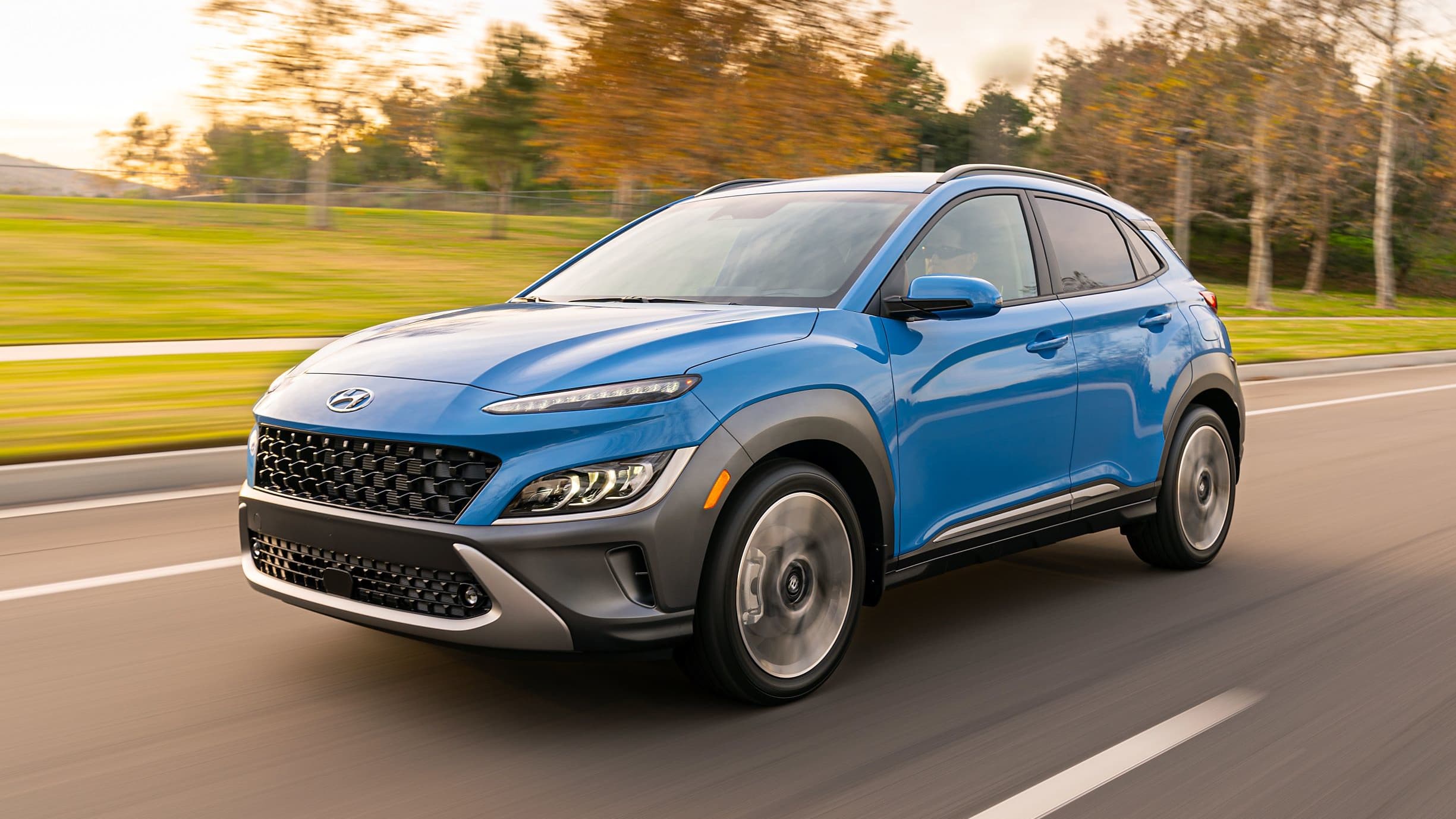 Blue 2022 Hyundai Kona driving on road