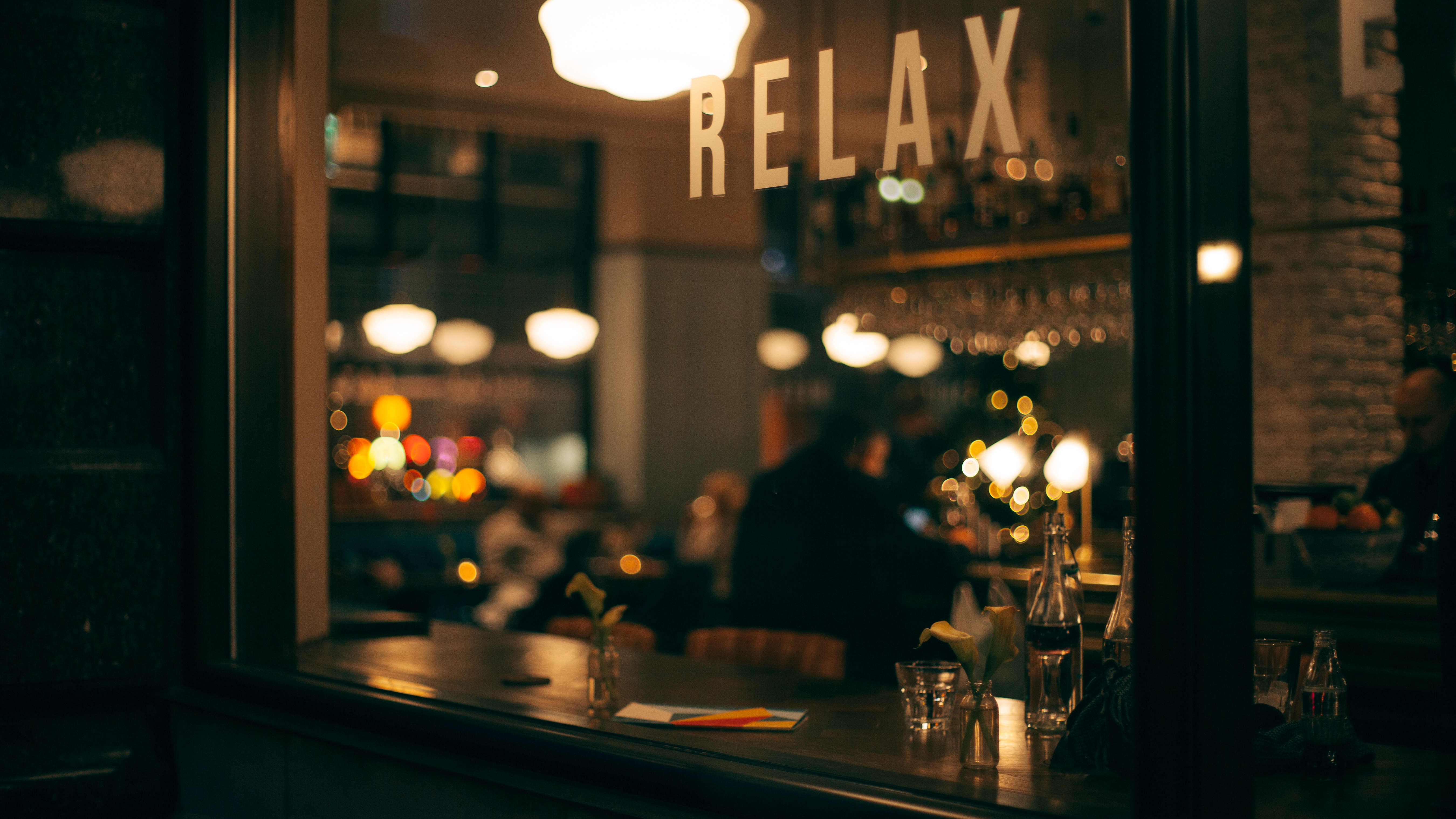 a bar with a sign saying "relax" hanging above.