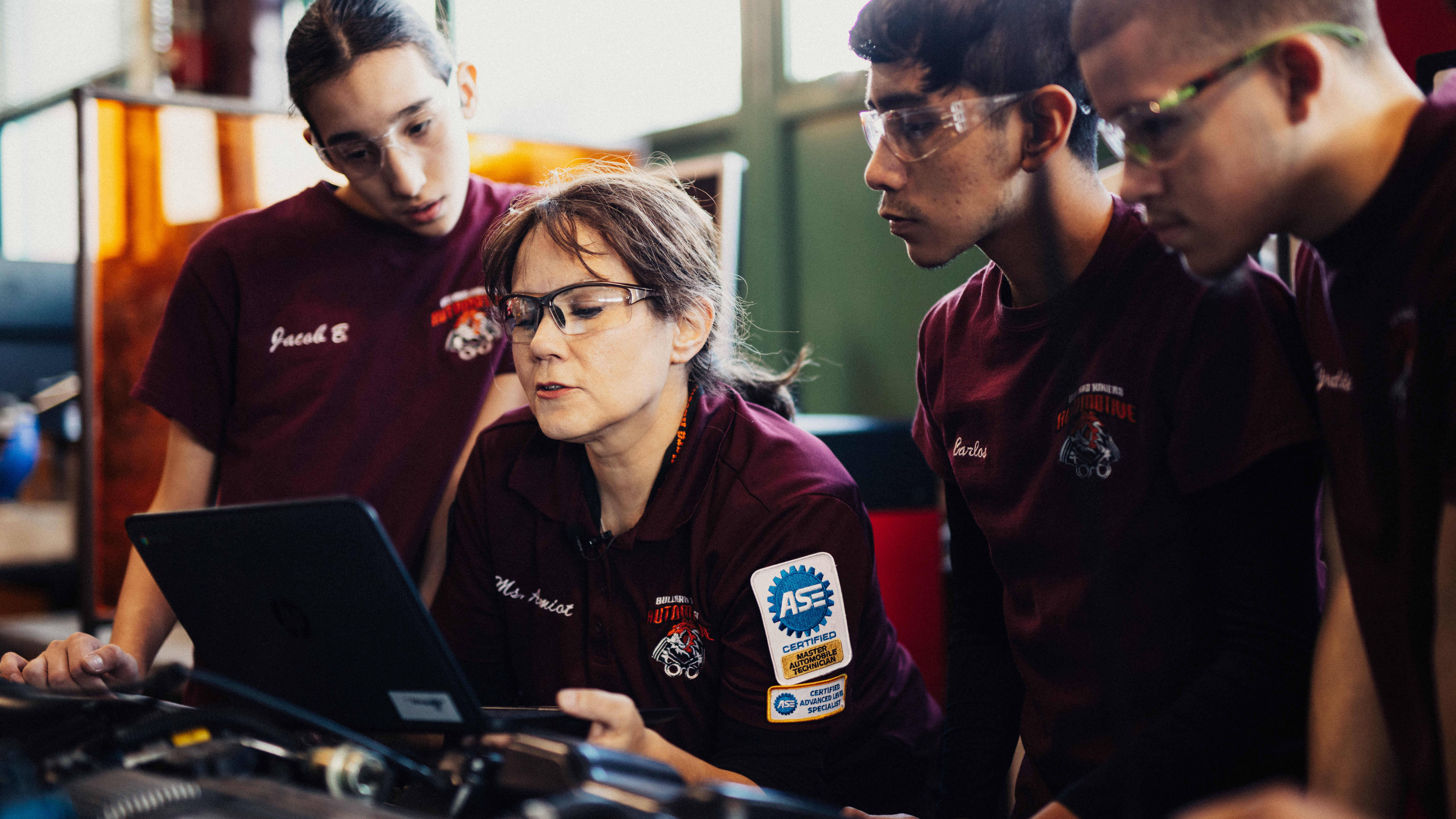 Harbor Freight Tools For Schools 2017 winner Roxanne Amiot sitting by computer with her students