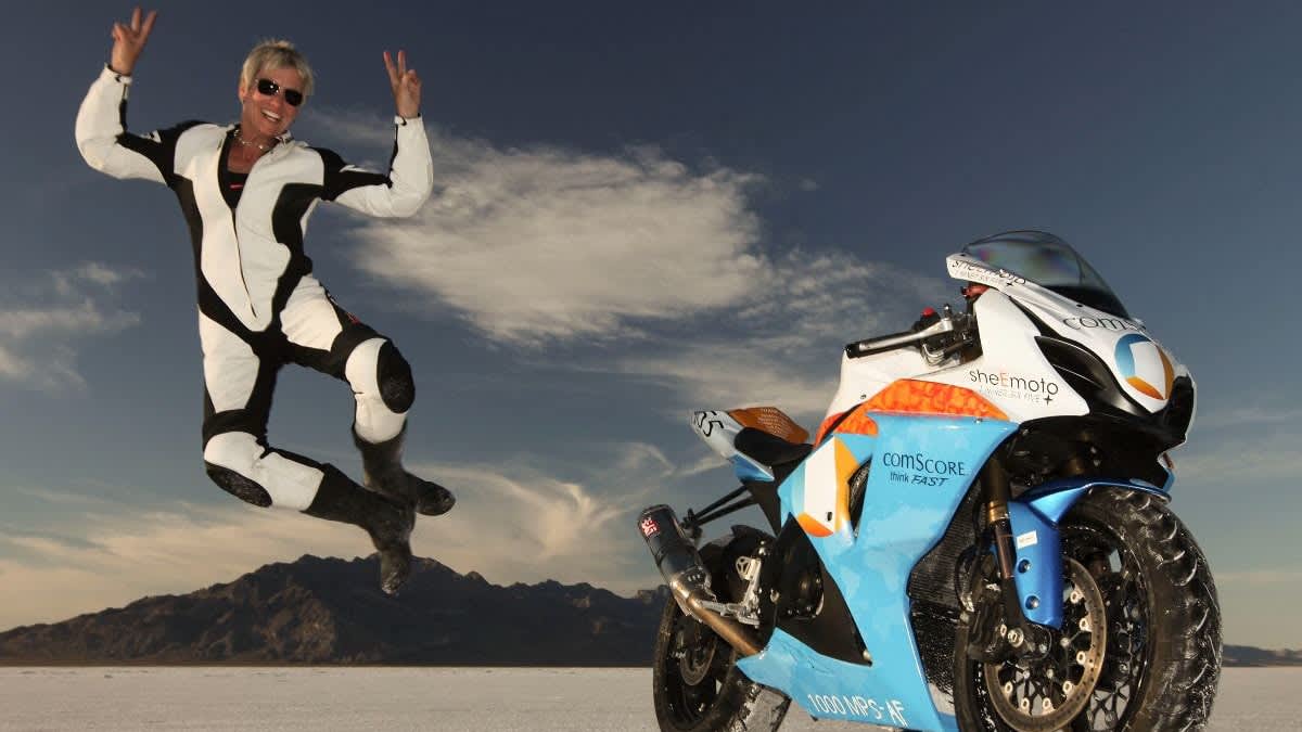 Motorcycle racer Erin Sills, 56, mid-air next to her motorcycle, jumping of joy after setting yet another land speed record.