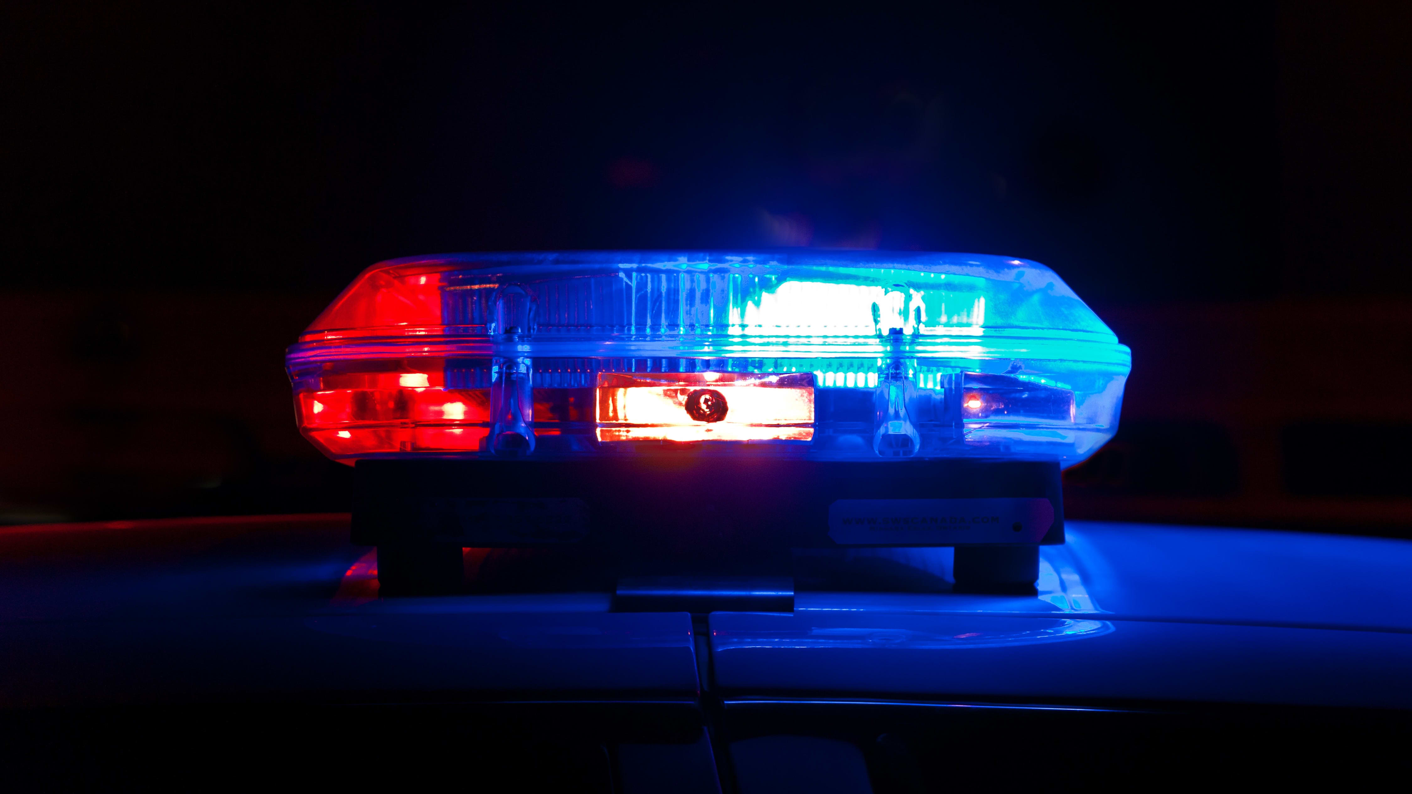 closeup of the blue lights on a police car in the dark.