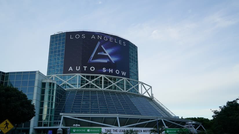 exterior photo of the Los Angeles convention center with the Los Angeles Auto Show sign draped over the entrance facade.