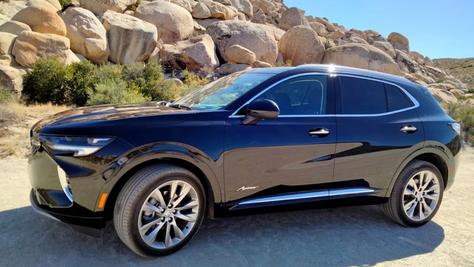 A 2022 Buick Envision Avenir parked with desert stones in the background.