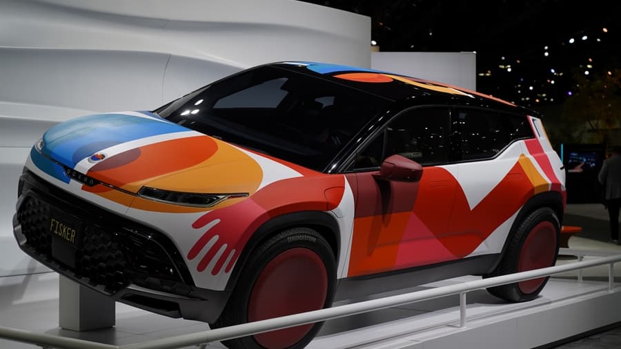 a brightly multi-colored Fisker SUV on a slanted display at the 2021 LA Auto Show