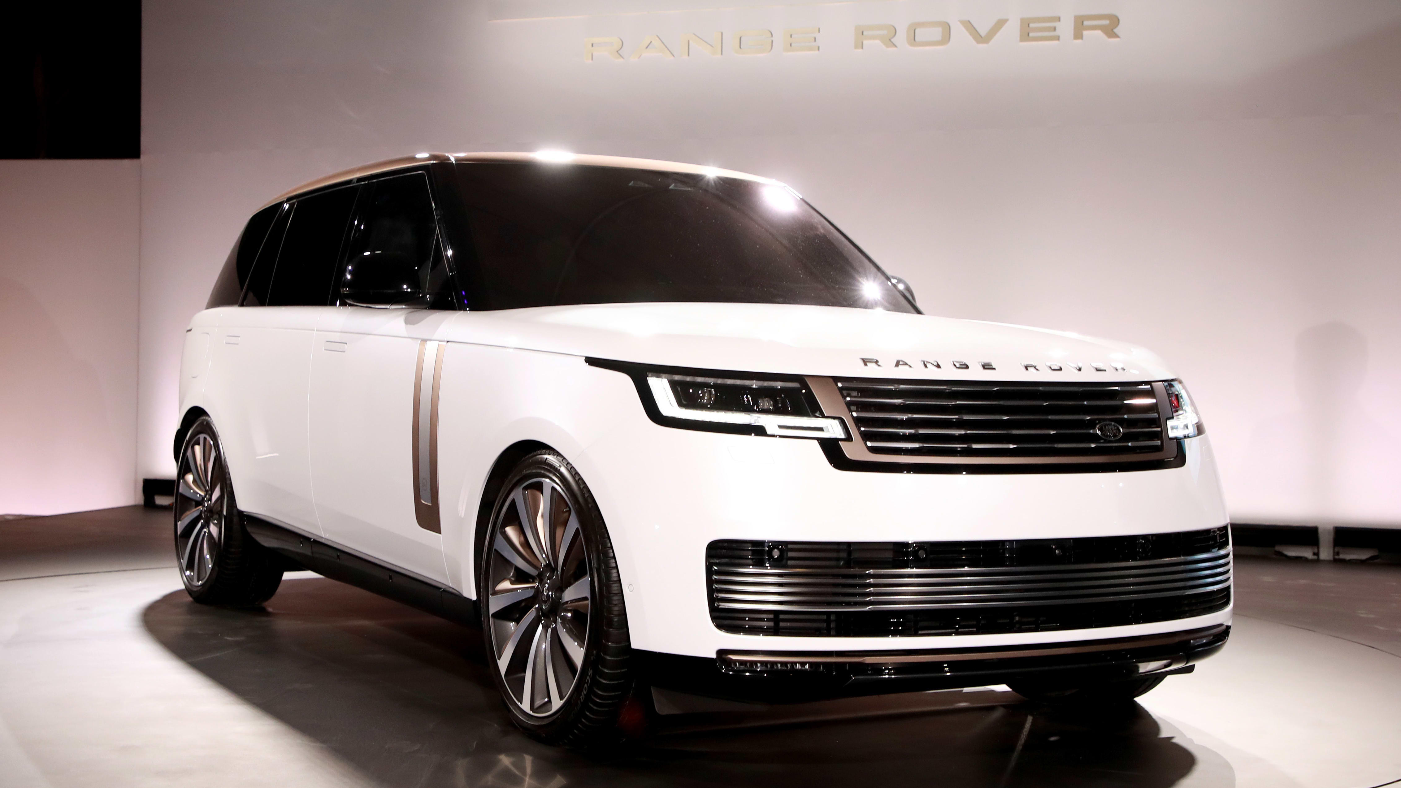 a white , brand new Land Rover Range Rover on display at a launch party.