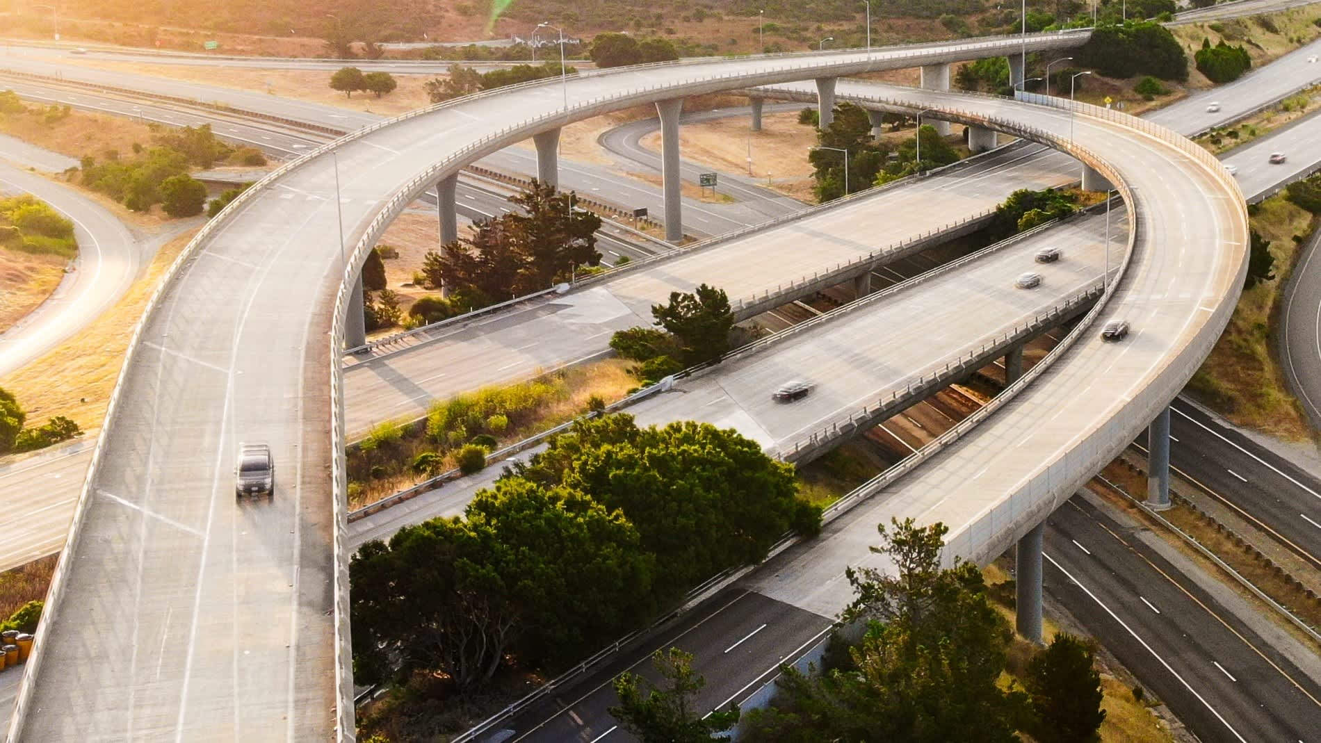 a small overpass over a California freeway, as seen from above.