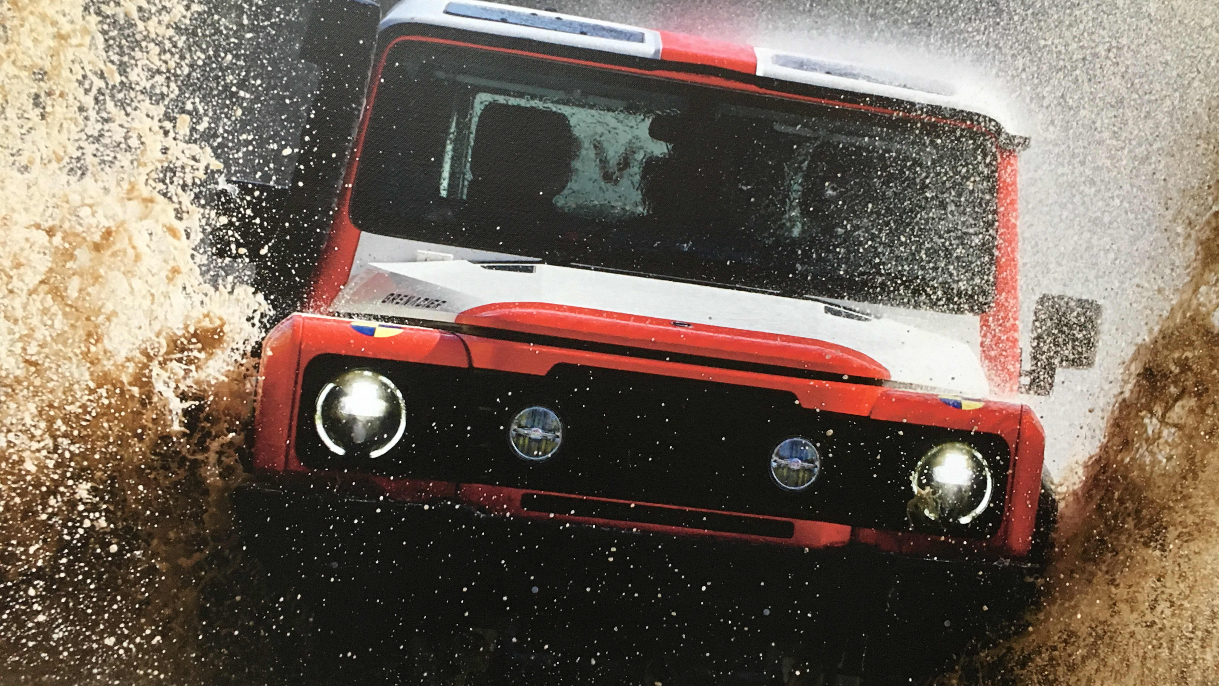 The INEOS Grenadier splashing through a huge puddle.