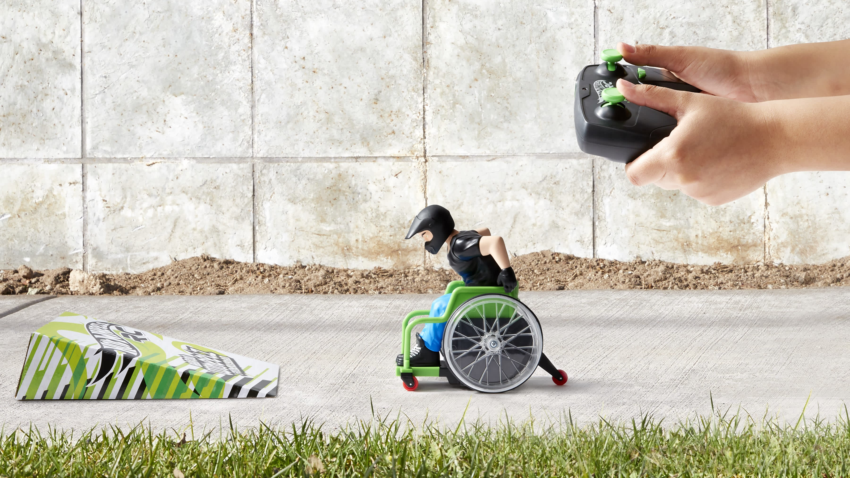 hot wheels remote control wheelchair lined up to jump off a ramp.