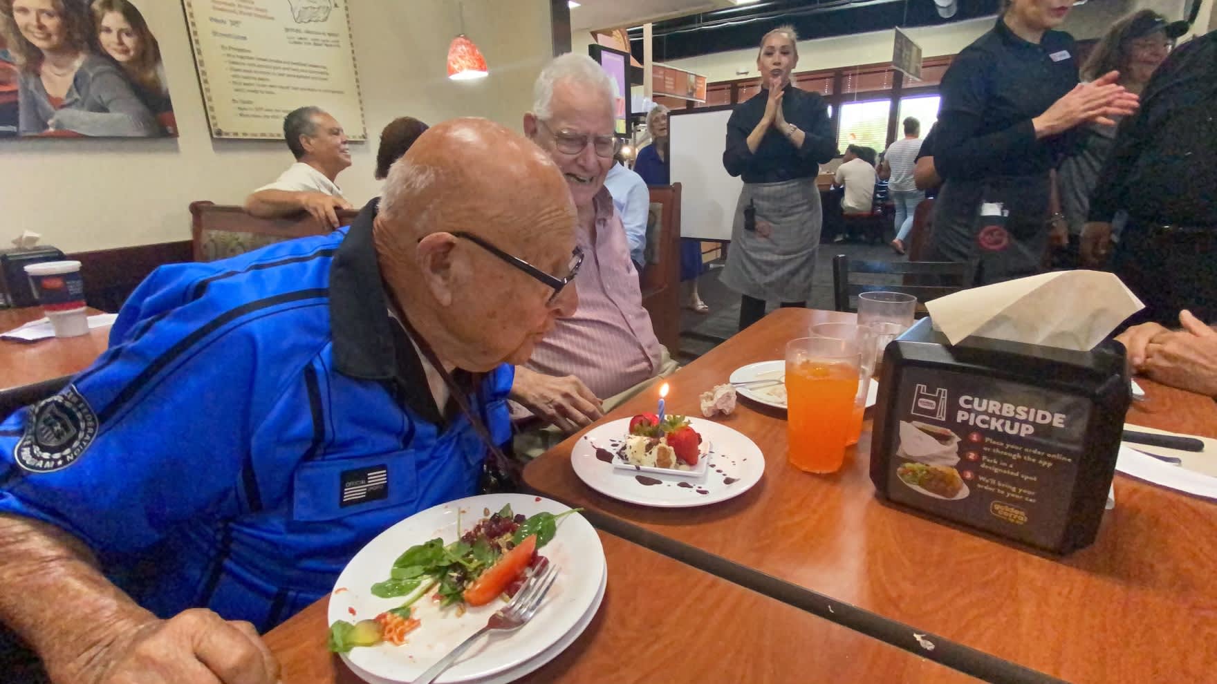 Ed Iskenderian blows out the one candle on his cake, celebrating his 101st birthday.