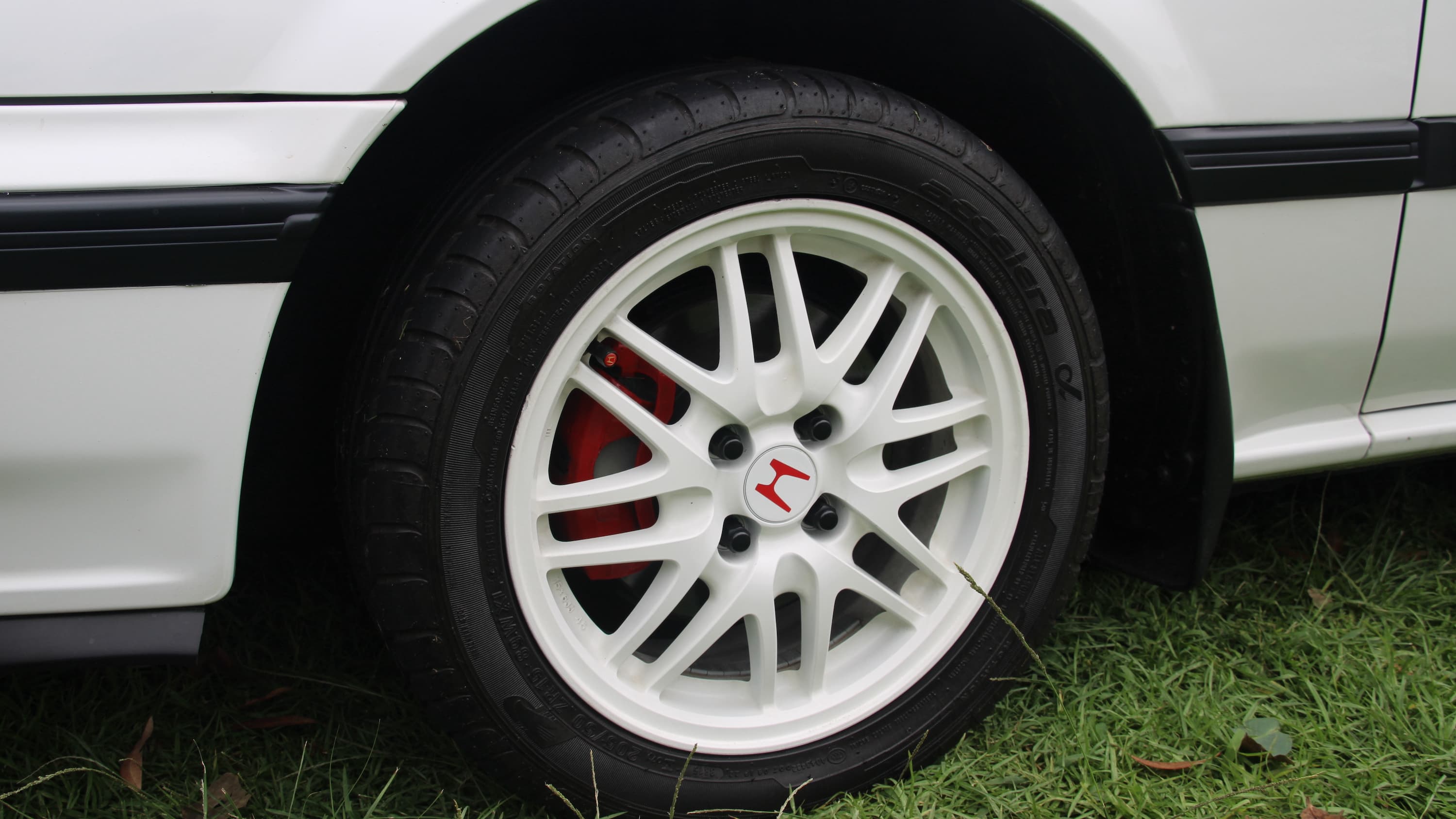 closeup image of a wheel on display at the 11th Annual Japanese Classic Car Show