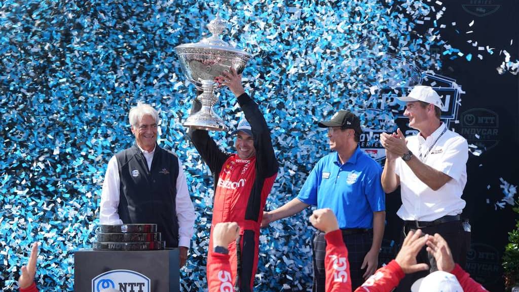 Race driver Will Power celebrating on his race car
