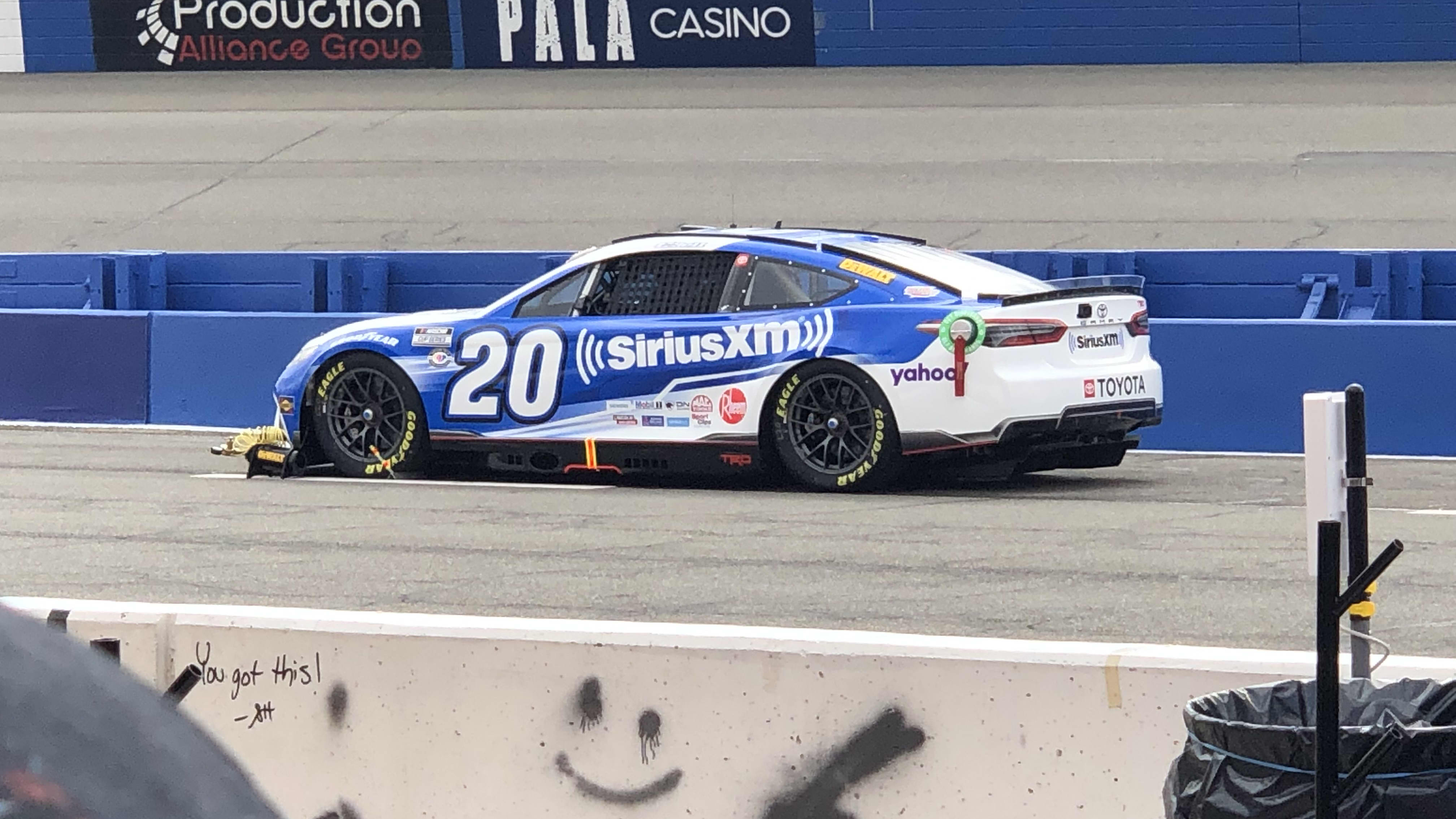 white and blue racer number 20 on the track at Auto Club Speedway Fontana