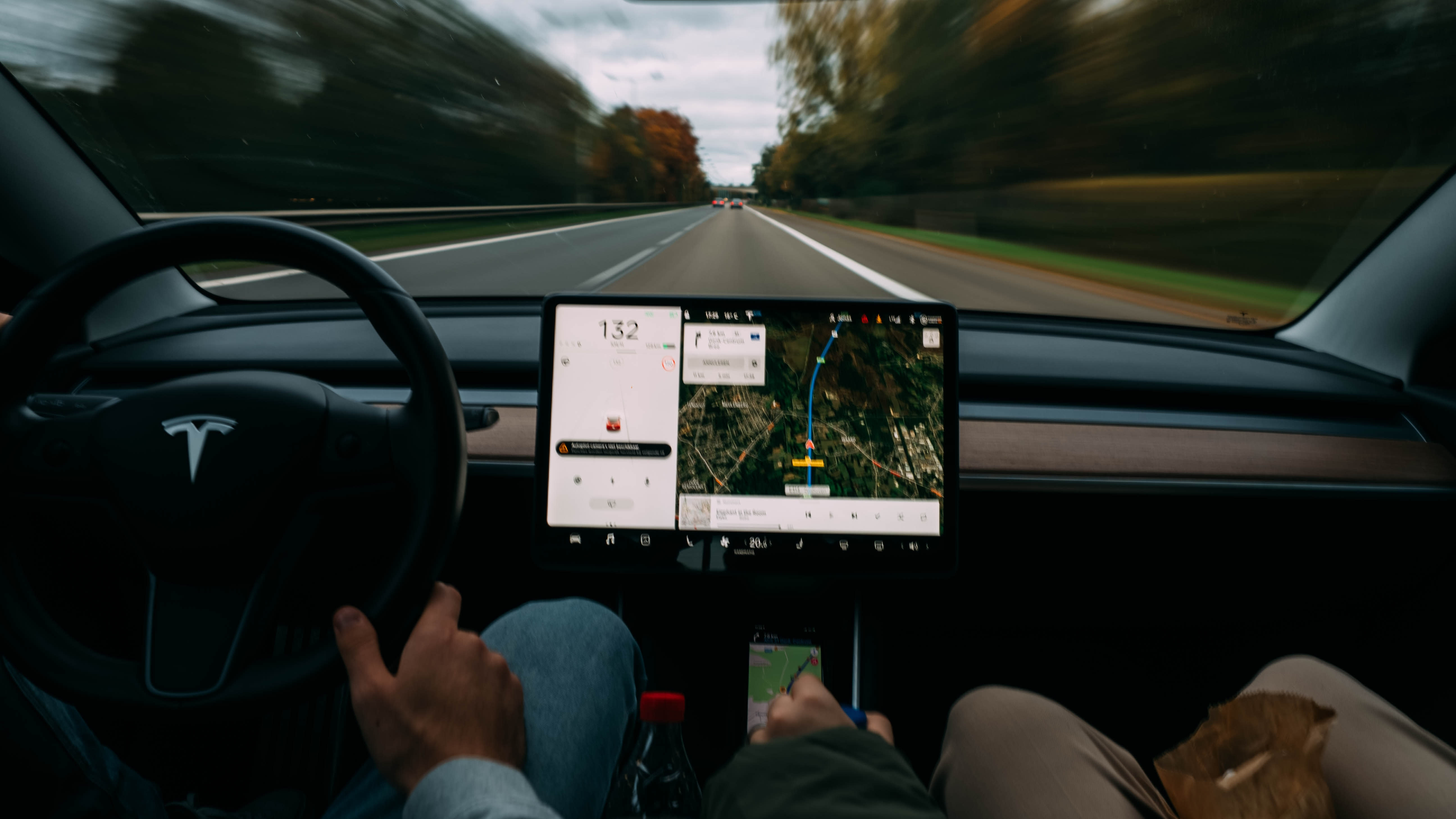 interior of a Tesla driving down the road.