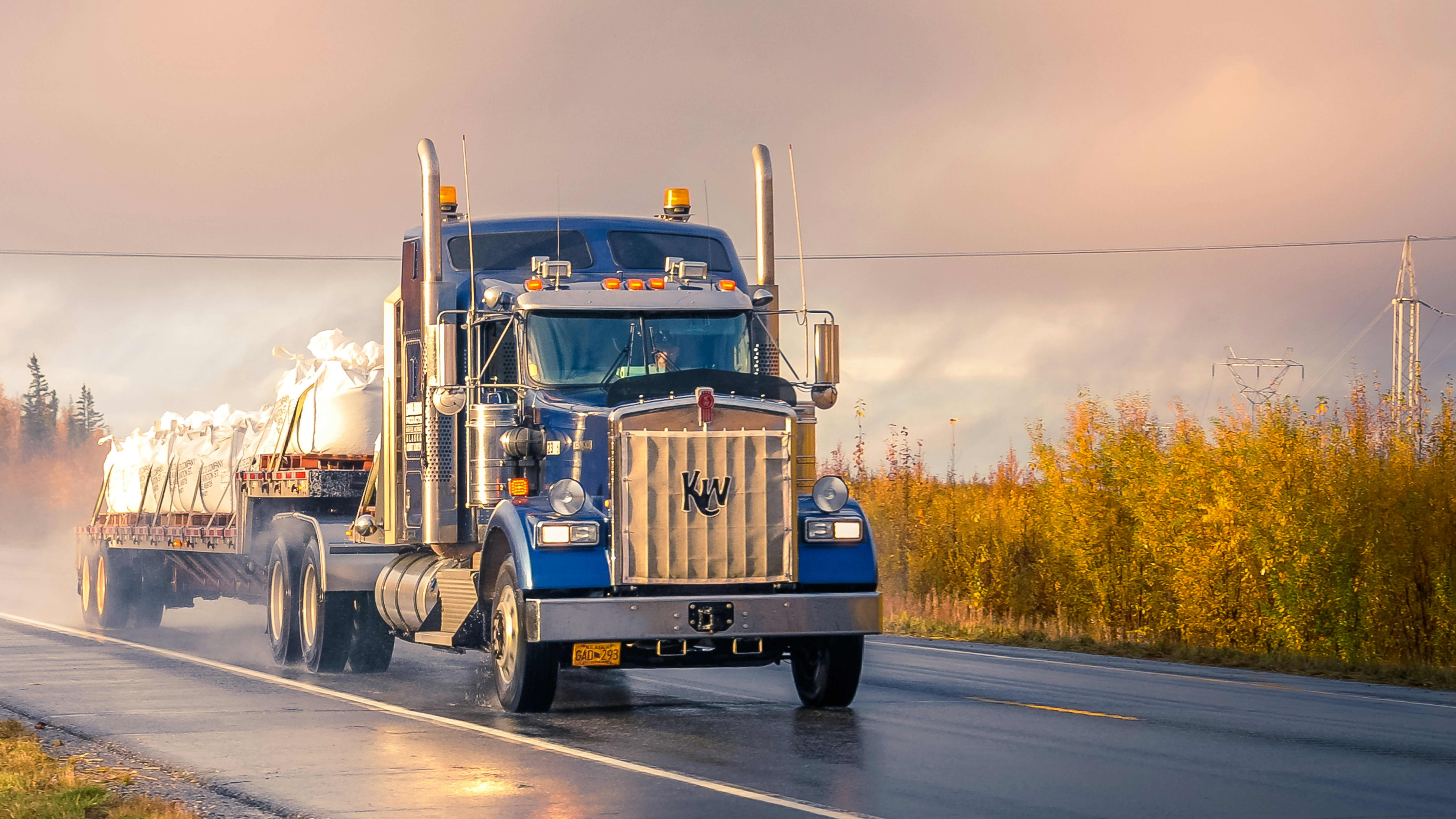 blue truck driving down country road