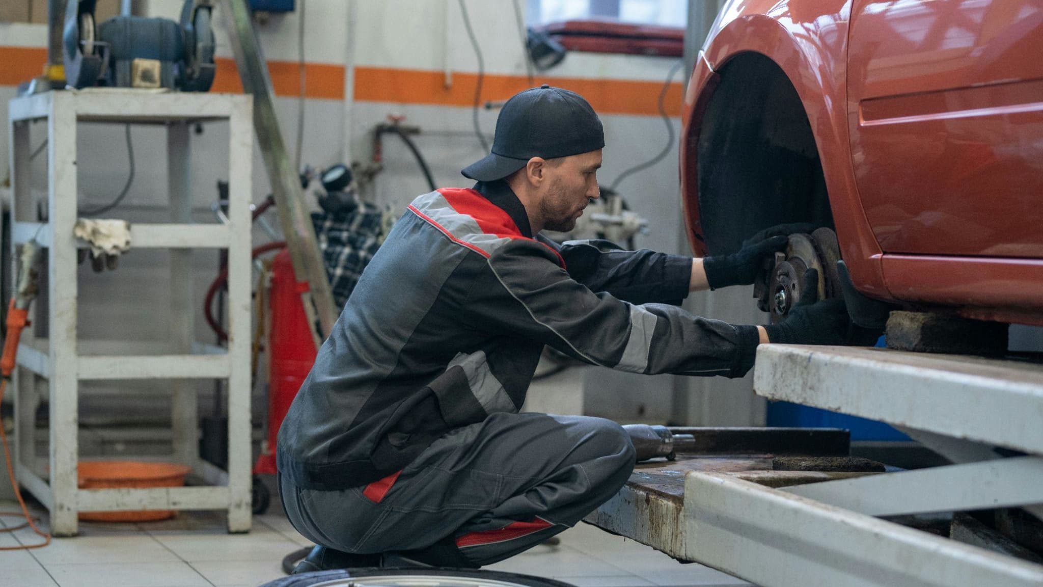 image of a mechanic working on a car