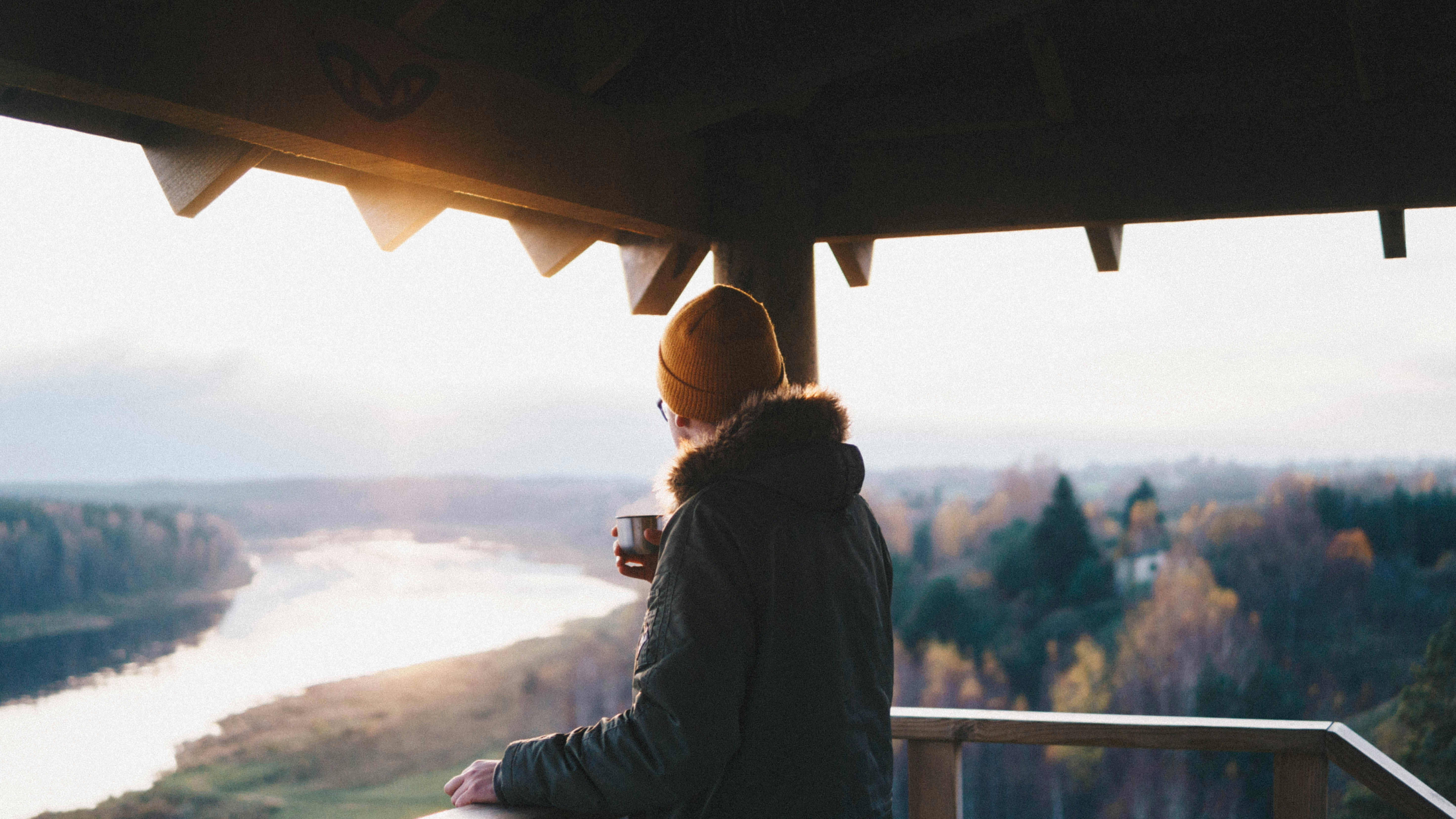man on porch with hot cup