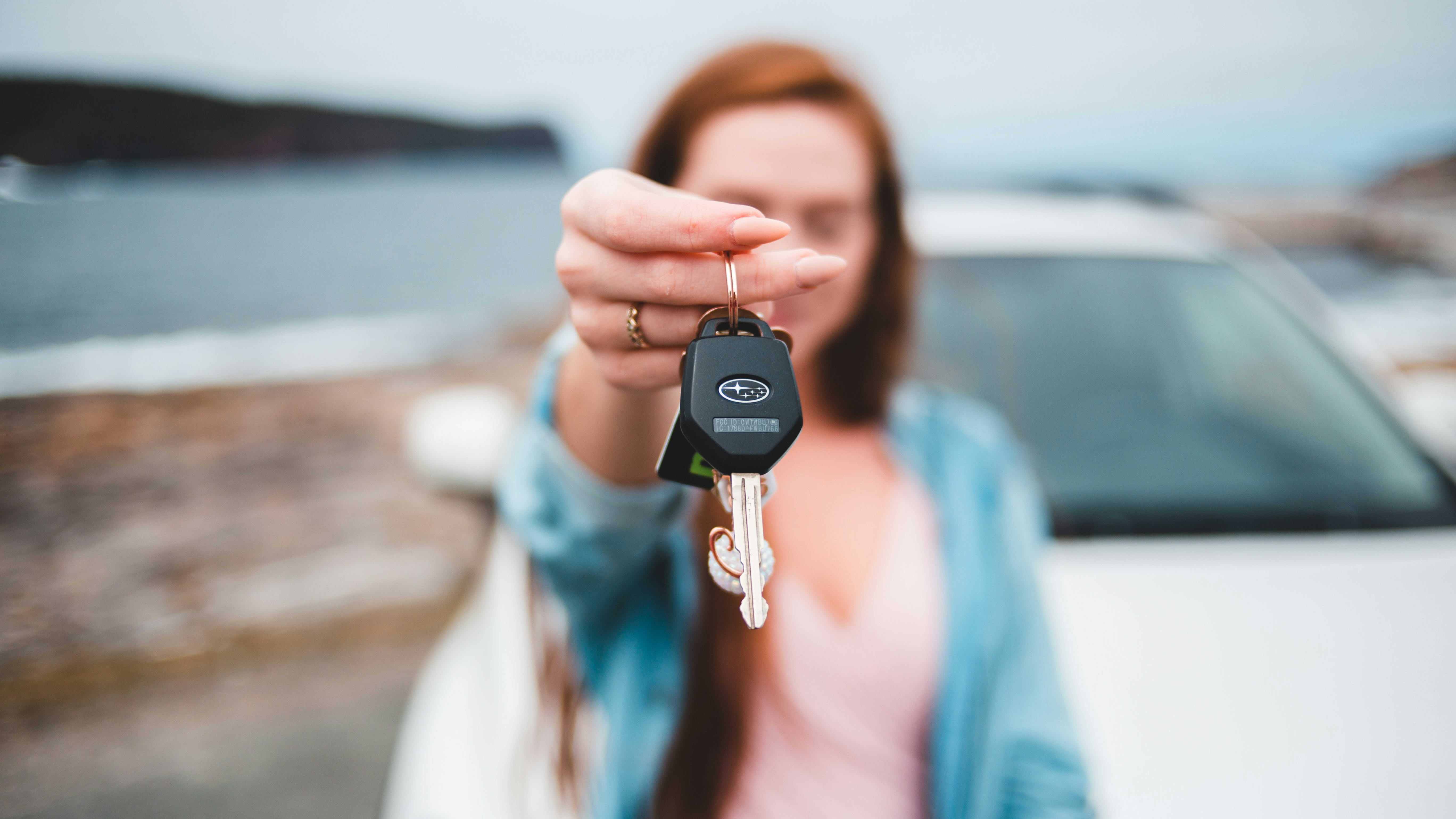 girl holding car key