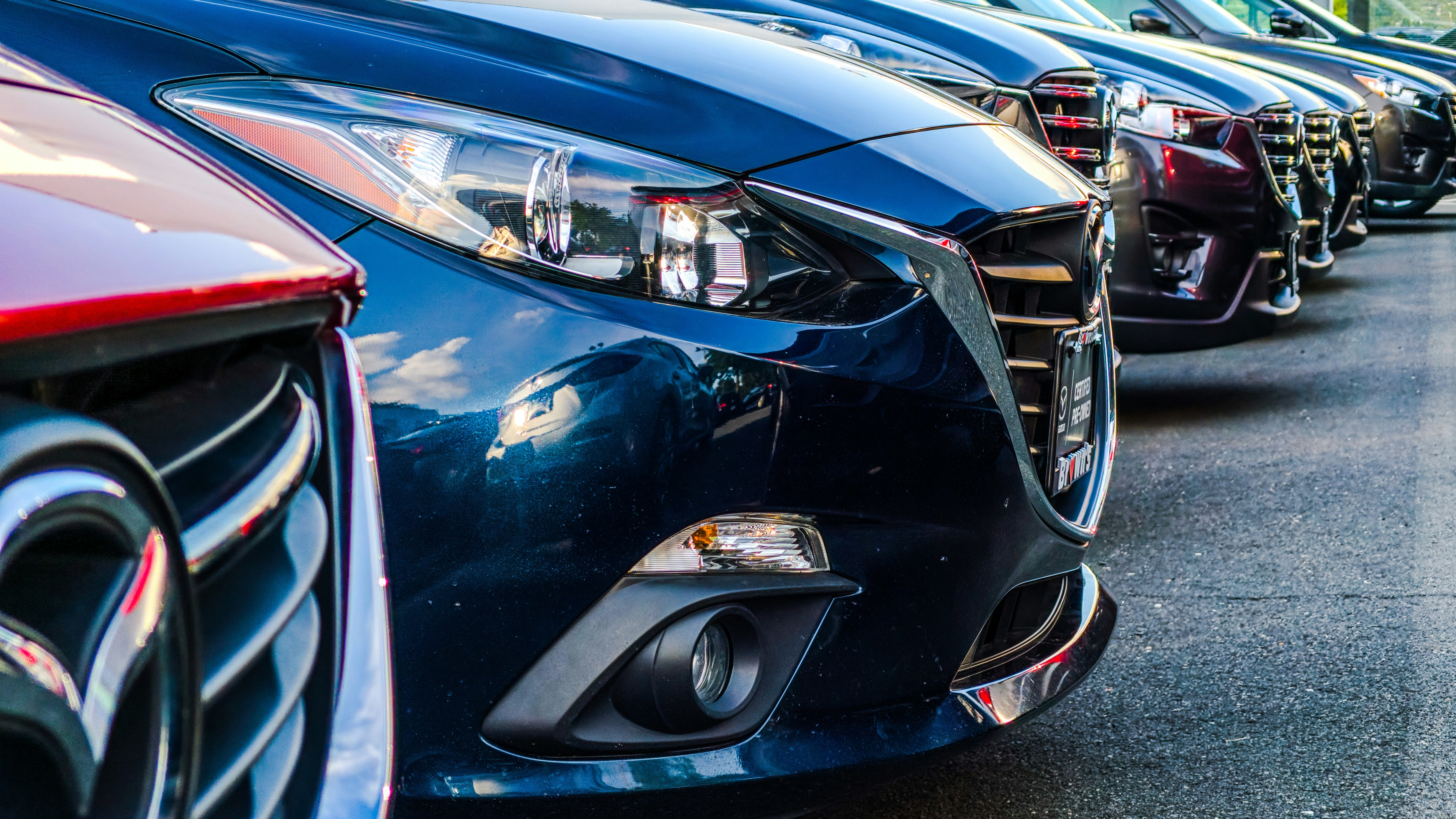 cars lined up for sale at dealership
