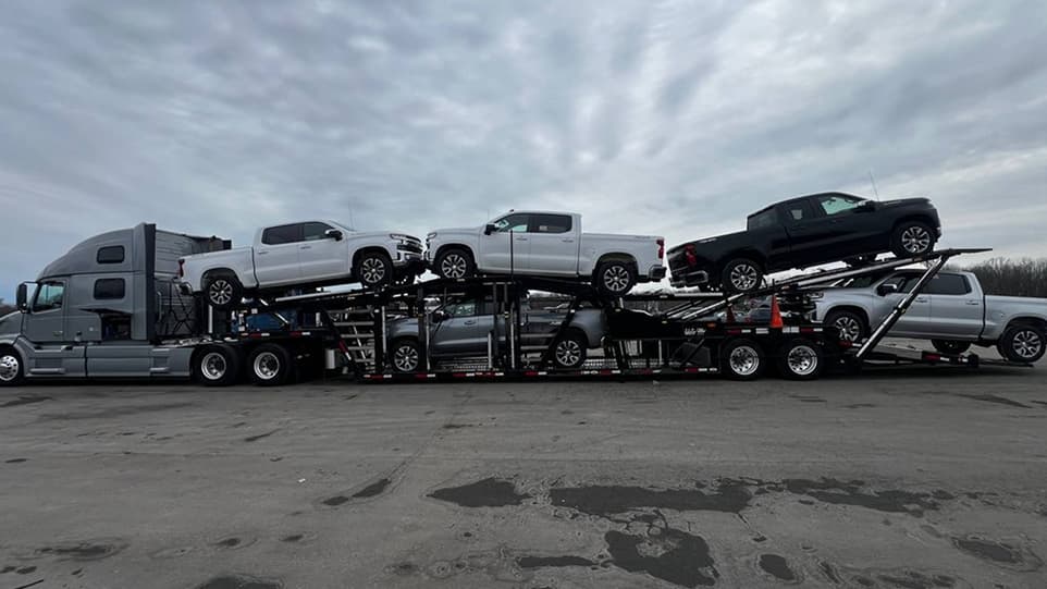 image of a truck loading vehicles for transport