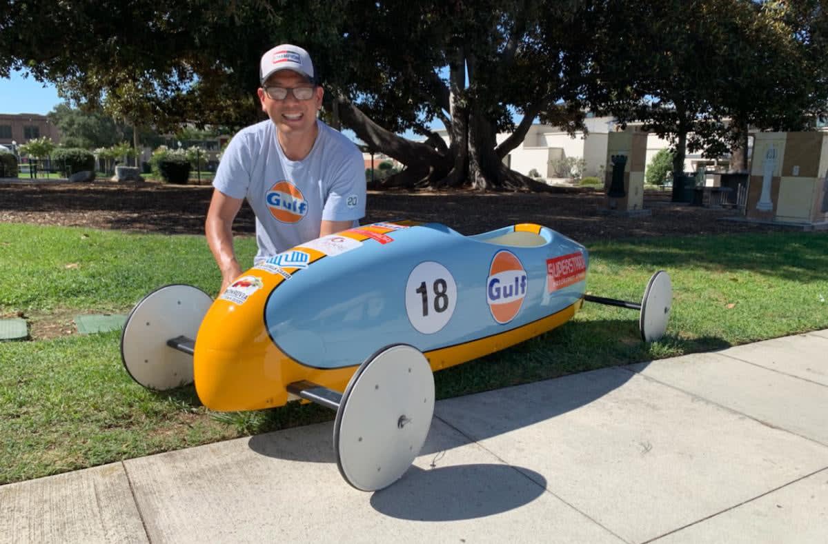 LA Car's Glenn Oyoung next to his Ferrari Brothers Body Shop-prepared Gulf Racing soap box car for the 2019 Monrovia Old Town Derby. Photo by Roy Nakano