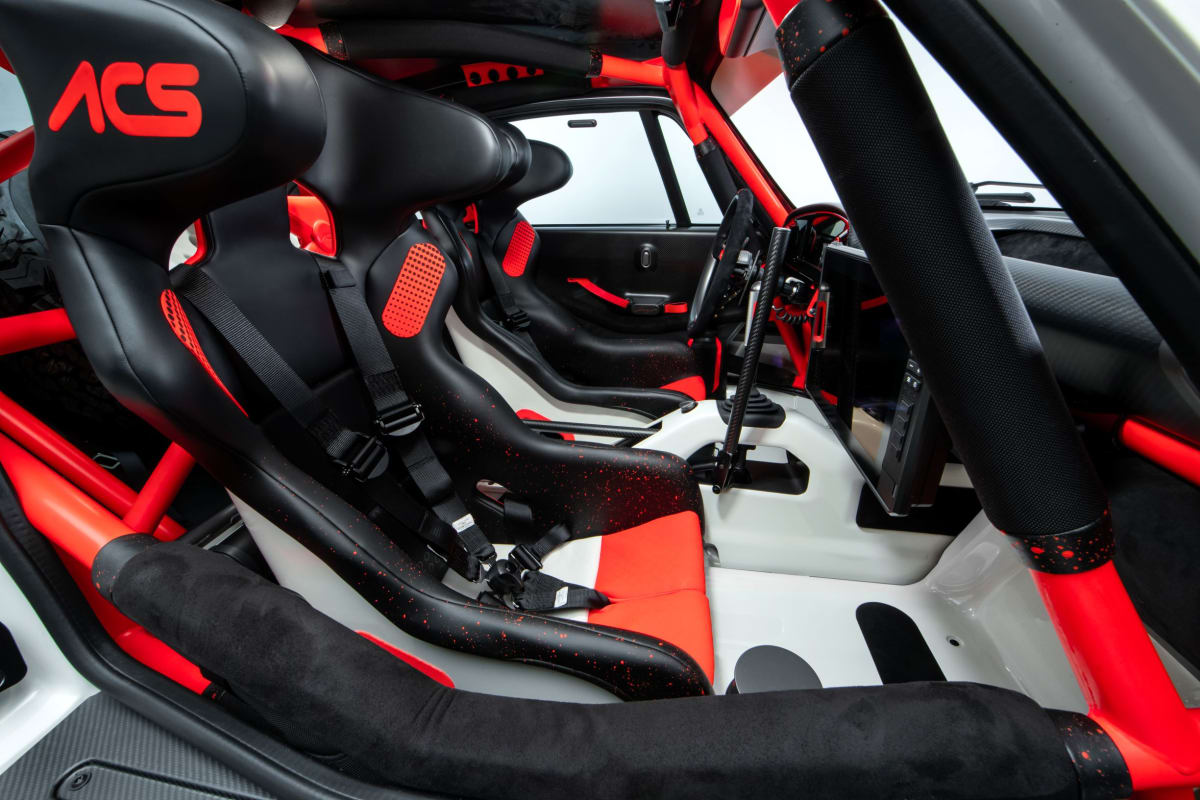 View from co-driver’s door showing driving environment with FIA specification race seats.