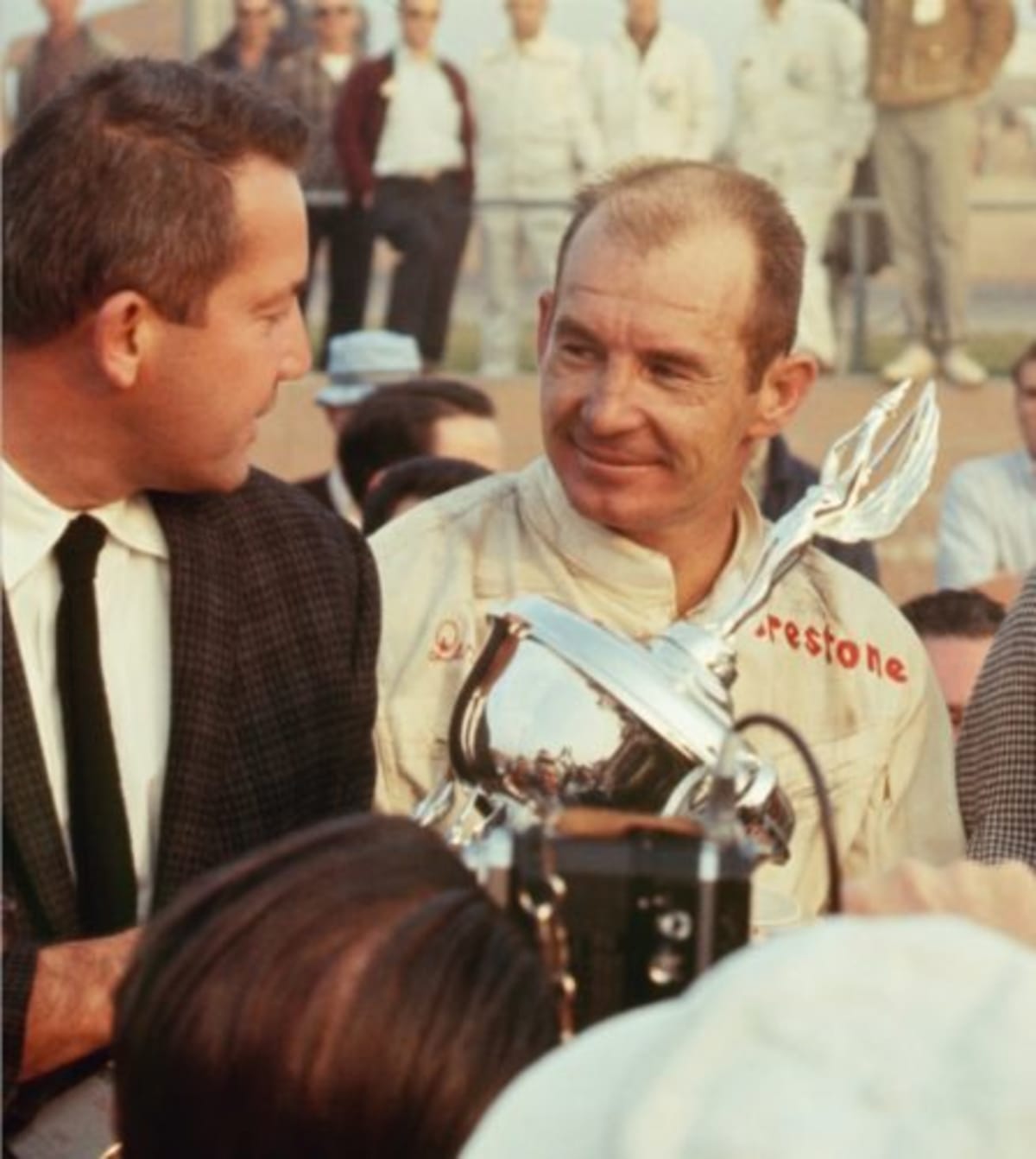 Jones accepts the winner’s trophy from race sponsor Robert E Petersen at the 1967 Motor Trend 500 at Riverside International Raceway