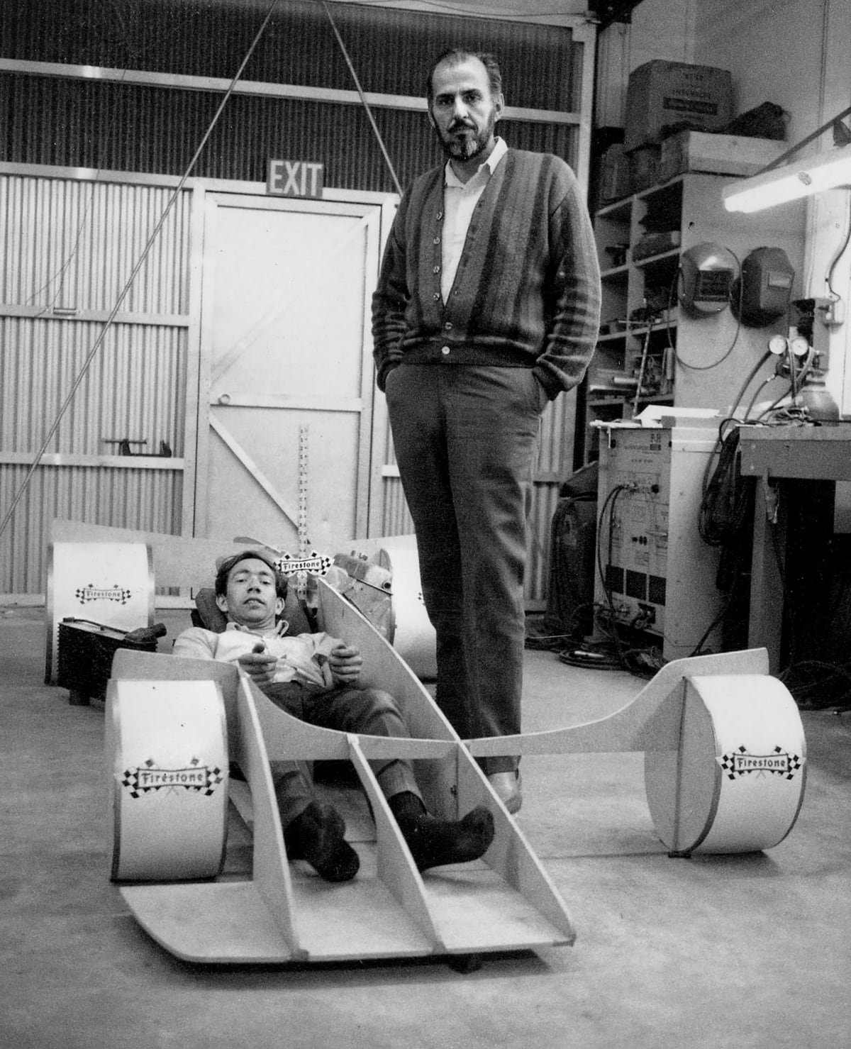 Dare to dream? Dream small … The idea man, Nichols towering over designer Trevor Harris who’s crammed into a mock-up of the mysterious Shadow racecar.