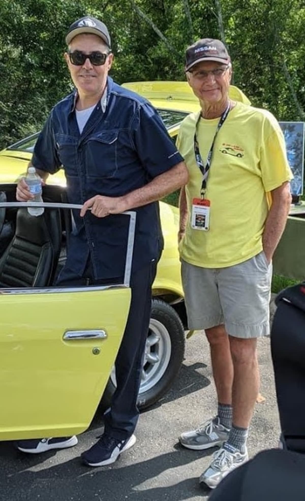 Datsun racer and collector Adam Carolla attended the event and helped with the judging. In the photo with his bodyguard.