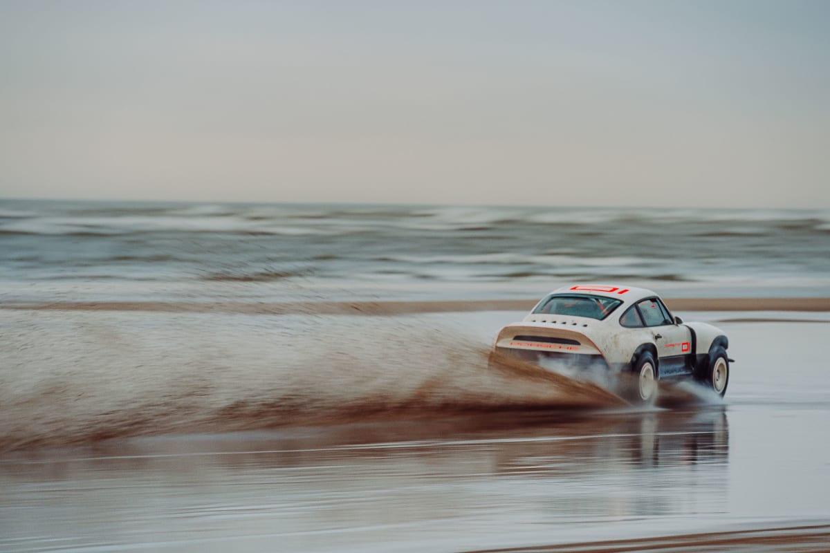 All-terrain Competition Study in Parallax White, Singer's first restoration developed to a client's motorsport specification shown at speed on sand.