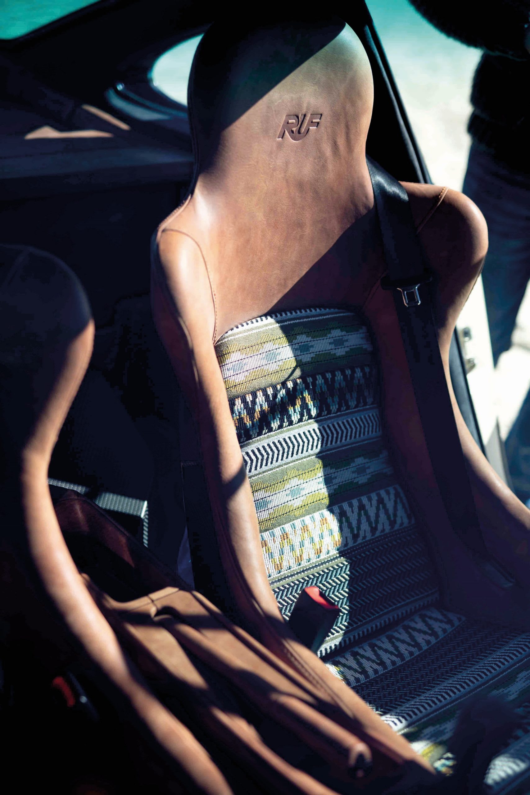 interior shot of a RUF Rodeo Concept car, featuring the drivers chair with a tan leather.