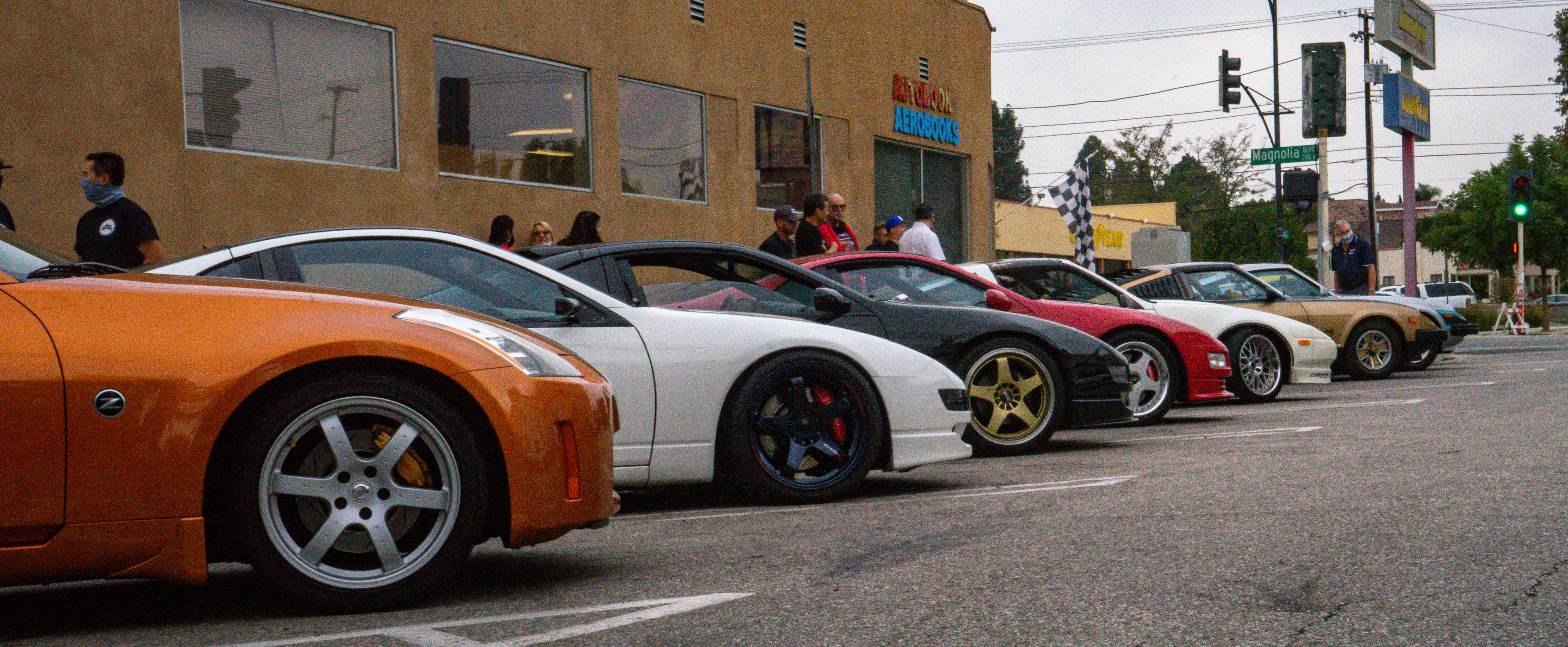 A group of 280s, 300s, 300Zx and a 350 with Autobooks bookstore as the backdrop.