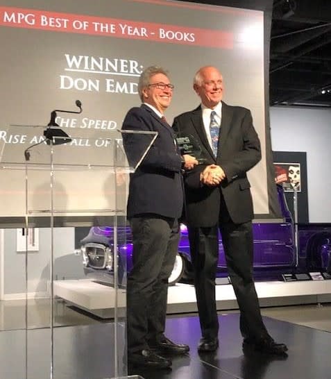 Don Taylor, one of the 2019 Motor Press Guild 'Best Book' committee judges, awards Don Emde First Place for "The Speed Kings: The Rise and Fall of the Motordromes".