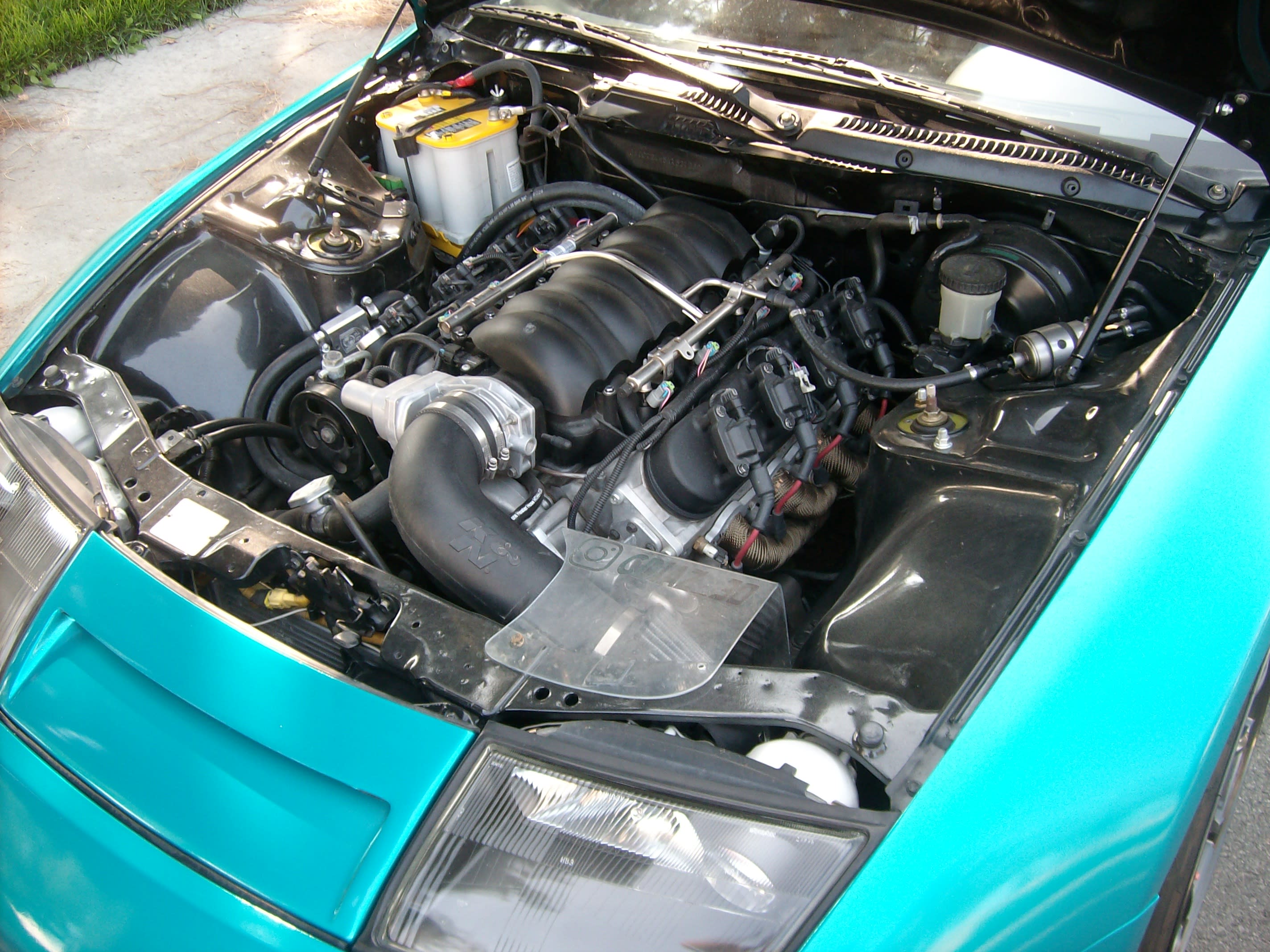 Va-Va-Va-Voom! Instead of the Twin Turbo V6 there’s a 6.2 liter 442 HP LS3 under the carbon fiber hood. Impeccable installation.