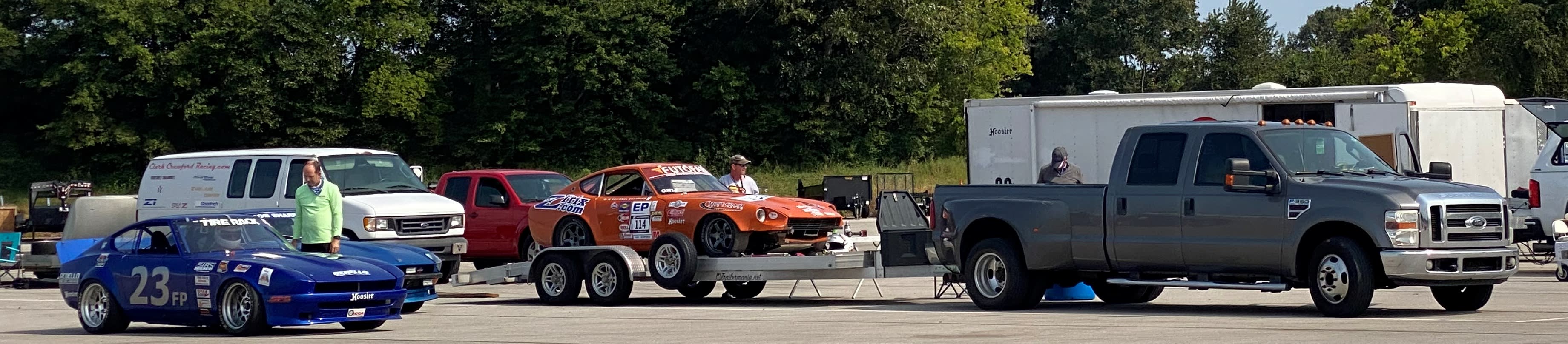 A familiar scene at any race track: towing vehicles, trailers and race cars. zcon