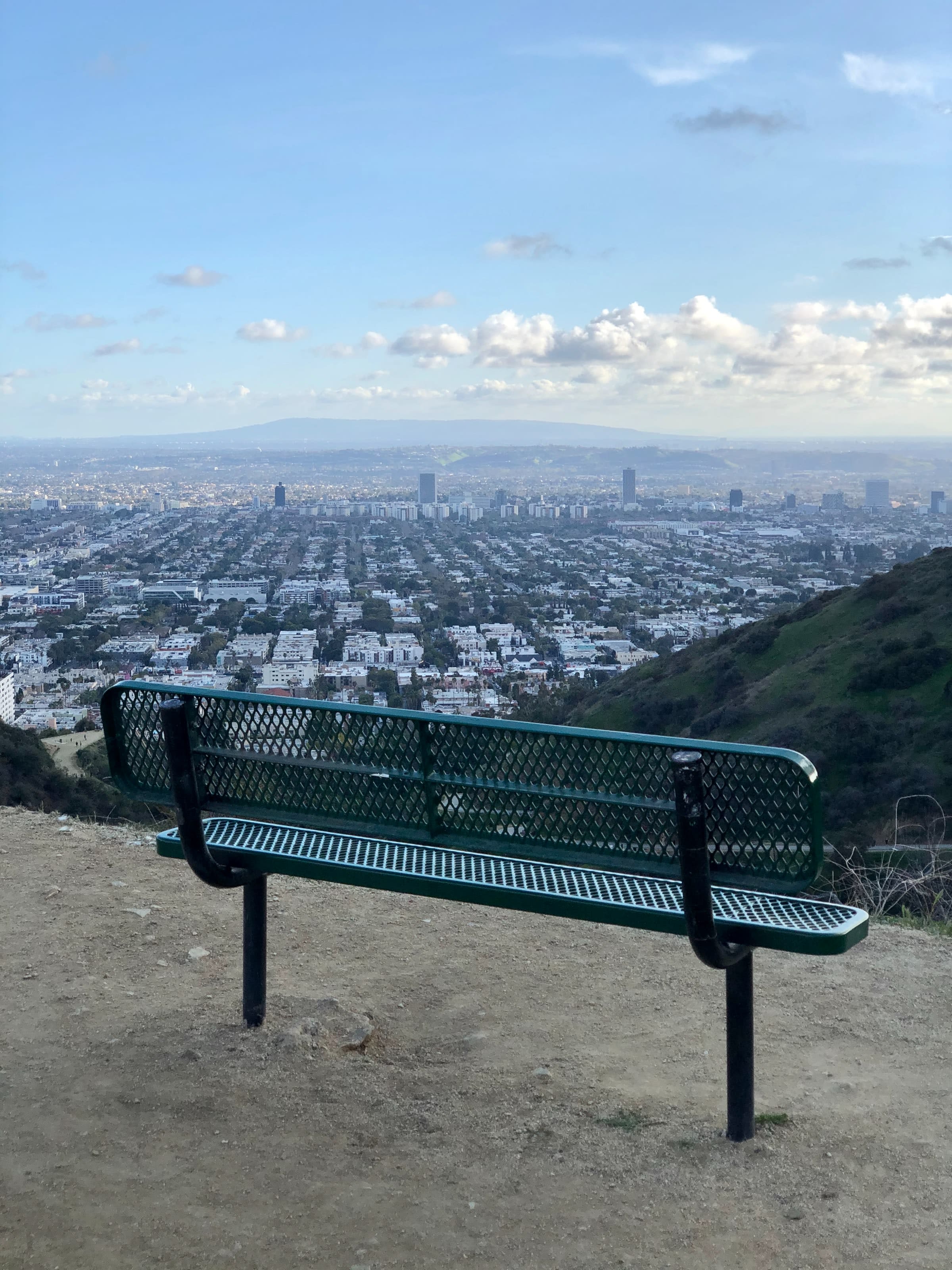 Green metal park bench in Runyon Canyon Park