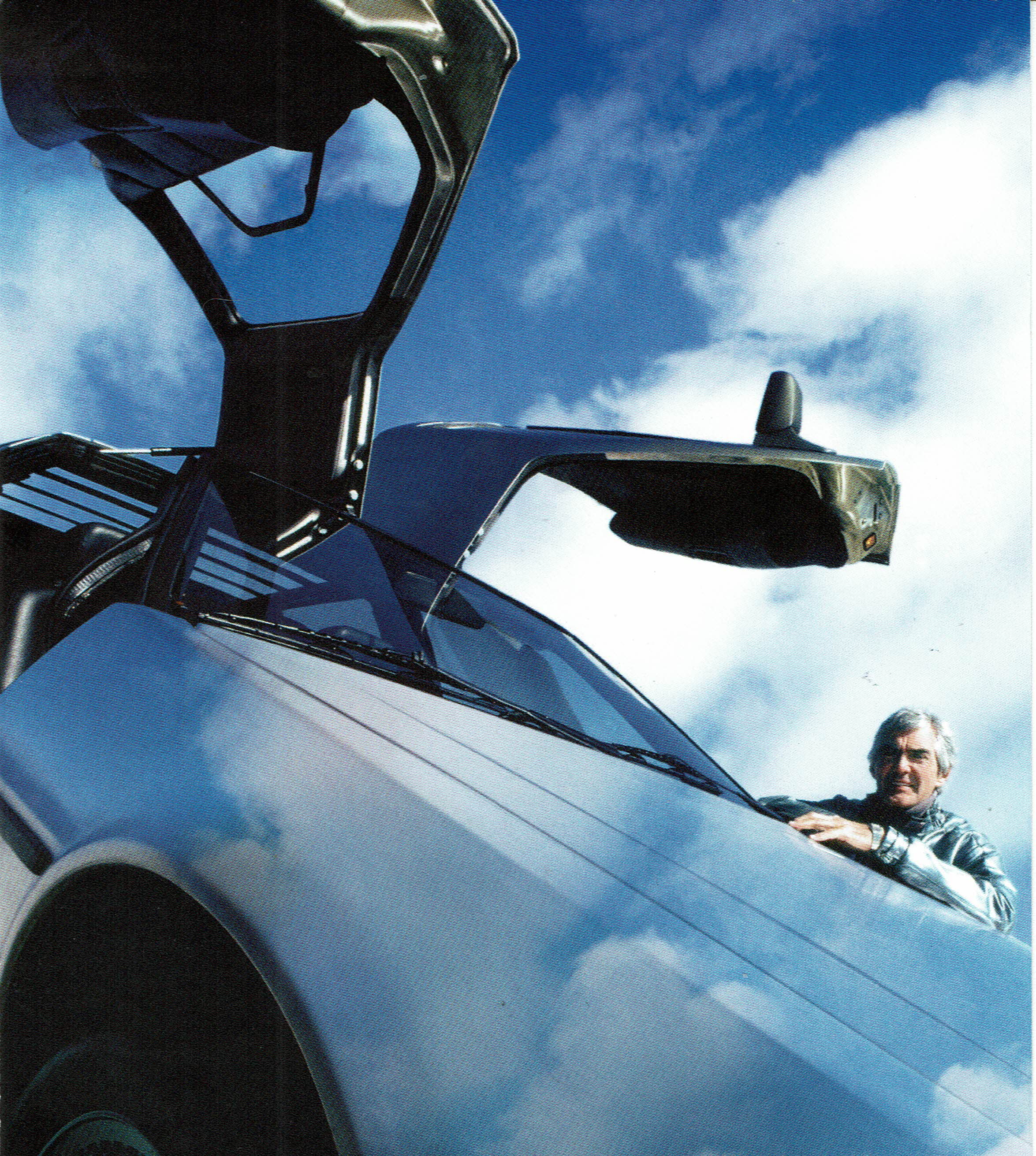 gullwing doors of the DMC-12 and the sky with clouds above